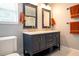 Elegant bathroom featuring a double vanity with granite countertop, modern fixtures, and ample storage at 14832 Royal Poinciana Dr, Orlando, FL 32828