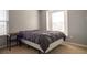 Bedroom with neutral decor, offering a calm and restful space, with a large window for natural light at 14832 Royal Poinciana Dr, Orlando, FL 32828