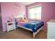 Charming bedroom with colorful decor, natural light, and whimsical wall art, perfect for a  at 14832 Royal Poinciana Dr, Orlando, FL 32828