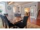 Dining room features a large wooden table, black chairs, and sliding glass doors to a study at 14832 Royal Poinciana Dr, Orlando, FL 32828