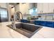 Kitchen island featuring a stainless sink, and countertops, oven, and backsplash at 14832 Royal Poinciana Dr, Orlando, FL 32828