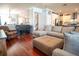 Spacious open-concept living room showing hardwood floors, seating area, and modern appliances in kitchen at 14832 Royal Poinciana Dr, Orlando, FL 32828