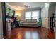 Inviting living room with hardwood floors, a comfortable couch, and bright lighting, perfect for relaxing or entertaining at 14832 Royal Poinciana Dr, Orlando, FL 32828