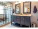 Elegant bathroom with a double sink vanity and a modern glass-enclosed shower at 14832 Royal Poinciana Dr, Orlando, FL 32828