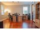 Bright office with multiple desks, hardwood floors, and ample natural light at 14832 Royal Poinciana Dr, Orlando, FL 32828