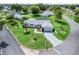 Aerial view of a well-maintained home with lush lawn, mature trees, and a circular driveway in a quiet neighborhood at 17819 Se 105Th Ct, Summerfield, FL 34491