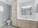 Bright bathroom featuring ample cabinet space, a clean white countertop, and tiled floor at 17819 Se 105Th Ct, Summerfield, FL 34491