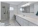 Bathroom features glass enclosed shower, large mirror and white vanity with ample countertop space at 17819 Se 105Th Ct, Summerfield, FL 34491