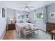 Inviting bedroom featuring hardwood floors, soft lighting, and a tranquil atmosphere at 17819 Se 105Th Ct, Summerfield, FL 34491