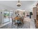 Cozy dining area adjacent to the kitchen with access to the lanai via sliding glass doors at 17819 Se 105Th Ct, Summerfield, FL 34491