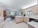 Eat-in kitchen with light wood cabinetry, white countertops, and a cozy dining area at 17819 Se 105Th Ct, Summerfield, FL 34491