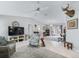Spacious living room featuring tiled floors, ceiling fan, and an abundance of natural light at 17819 Se 105Th Ct, Summerfield, FL 34491