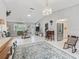 Open-concept living area featuring tile flooring, comfortable seating, and seamless transition to the kitchen at 17819 Se 105Th Ct, Summerfield, FL 34491
