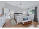 Comfortable main bedroom with hardwood floors, a ceiling fan, and natural light at 17819 Se 105Th Ct, Summerfield, FL 34491
