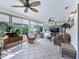 Bright and airy sun room featuring tile flooring, large windows and comfortable seating at 17819 Se 105Th Ct, Summerfield, FL 34491