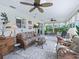 Comfortable sunroom with tile flooring, large windows, ceiling fans and comfortable seating at 17819 Se 105Th Ct, Summerfield, FL 34491