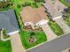 Charming single-story home boasts a well-manicured lawn, complemented by lush landscaping and a cozy, inviting facade at 17916 Se 87Th Melrose Ct, The Villages, FL 32162