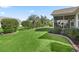 Well-manicured backyard with mature landscaping and screened lanai at 17916 Se 87Th Melrose Ct, The Villages, FL 32162