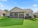 Well-maintained backyard features a screened lanai and manicured lawn at 17916 Se 87Th Melrose Ct, The Villages, FL 32162