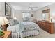 Cozy bedroom featuring carpet floors, natural light, and a ceiling fan at 17916 Se 87Th Melrose Ct, The Villages, FL 32162