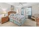 Comfortable bedroom with a decorative bedspread, ceiling fan, and natural light at 17916 Se 87Th Melrose Ct, The Villages, FL 32162