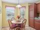 Bright dining area with a wood table, four chairs, and a view to the exterior at 17916 Se 87Th Melrose Ct, The Villages, FL 32162