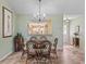 Light-filled dining room with tile floors, a glass table, and a view of the adjoining kitchen at 17916 Se 87Th Melrose Ct, The Villages, FL 32162