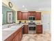 Well-equipped kitchen features stainless steel appliances and rich wood cabinetry at 17916 Se 87Th Melrose Ct, The Villages, FL 32162