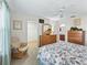 Bright main bedroom features a walk-in closet, en-suite bathroom, and cozy seating area at 17916 Se 87Th Melrose Ct, The Villages, FL 32162