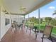 Screened patio with tiled floor, ceiling fan and outdoor furniture at 17916 Se 87Th Melrose Ct, The Villages, FL 32162