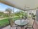 Covered patio with outdoor seating, overlooking well-manicured backyard at 17916 Se 87Th Melrose Ct, The Villages, FL 32162