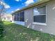 Expansive backyard with a screened-in lanai and lush green lawn for outdoor enjoyment at 1914 Armondo Dr, The Villages, FL 32159