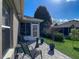 Well-maintained backyard patio with outdoor seating and a neatly landscaped lawn at 1914 Armondo Dr, The Villages, FL 32159