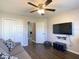 Bedroom featuring a ceiling fan, closet with sliding doors, and wood-look flooring at 1914 Armondo Dr, The Villages, FL 32159