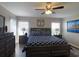 Serene bedroom featuring dark wood furniture, soft lighting, and a large picture window at 1914 Armondo Dr, The Villages, FL 32159