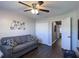 Bedroom with a gray sofa, ceiling fan, and closet with sliding doors at 1914 Armondo Dr, The Villages, FL 32159