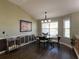 Dining room with dark hardwood flooring, a modern chandelier, and large windows at 1914 Armondo Dr, The Villages, FL 32159