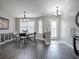 Bright dining room with modern lighting and a view of the front entrance at 1914 Armondo Dr, The Villages, FL 32159
