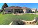 Well-maintained single-story home with lush green lawn, landscaping, and an attached two-car garage at 1914 Armondo Dr, The Villages, FL 32159