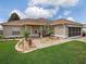 Charming home with well-manicured lawn, landscaped walkway, and inviting entrance at 1914 Armondo Dr, The Villages, FL 32159