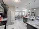 Modern kitchen with granite countertops and stainless steel appliances with an open floorplan at 1914 Armondo Dr, The Villages, FL 32159