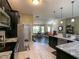 Modern kitchen with stainless steel appliances and a seamless view into the dining area at 1914 Armondo Dr, The Villages, FL 32159