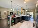 Stylish kitchen with granite countertops, stainless steel appliances, and an open-concept design at 1914 Armondo Dr, The Villages, FL 32159