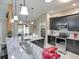 Modern kitchen featuring granite countertops, stainless steel appliances, and stylish pendant lighting at 1914 Armondo Dr, The Villages, FL 32159