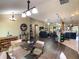 Open-concept living area with dining and kitchen, creating a bright and inviting space at 1914 Armondo Dr, The Villages, FL 32159