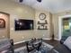 Cozy living room with dark hardwood floors, a large flat screen tv, and neutral paint at 1914 Armondo Dr, The Villages, FL 32159