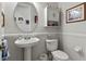 Compact bathroom featuring a pedestal sink, toilet, and stylish fixtures at 19624 Spring Oak Dr, Eustis, FL 32736