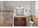 Bathroom vanity with granite countertop and tiled shower at 19624 Spring Oak Dr, Eustis, FL 32736