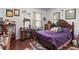 Comfortable bedroom featuring hardwood floors, a desk, and ample natural light at 19624 Spring Oak Dr, Eustis, FL 32736