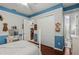 Cozy bedroom with hardwood floors, blue trim and a charming vanity at 19624 Spring Oak Dr, Eustis, FL 32736